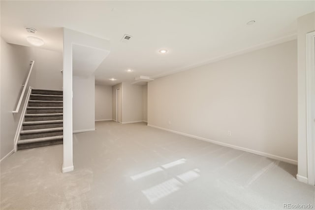 finished below grade area featuring visible vents, baseboards, stairs, carpet floors, and recessed lighting