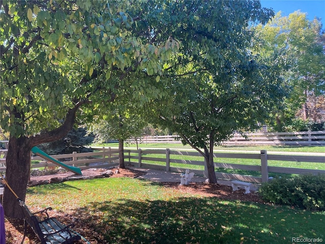 view of yard with a rural view and fence