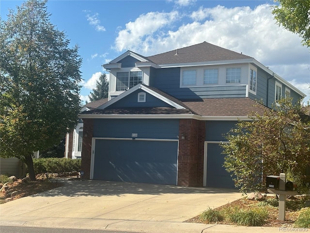 traditional-style home featuring a garage, brick siding, driveway, and roof with shingles