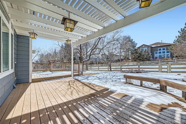 snow covered deck with a pergola