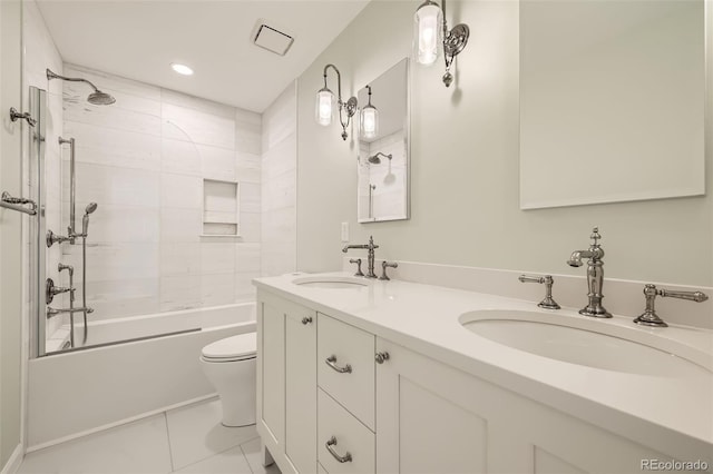 full bathroom featuring double vanity, bathtub / shower combination, a sink, and toilet