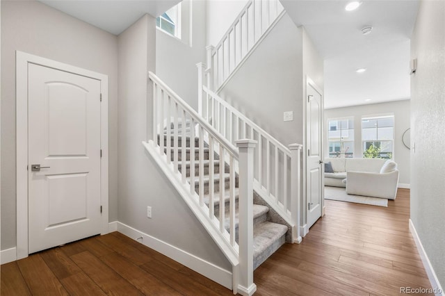 1632 Saddlesmith Pl, Castle Pines, CO 80108 - stairway featuring healthy amount of natural light, hardwood / wood-style floors, baseboards, and recessed lighting