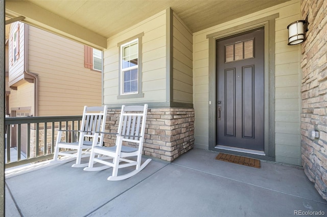 1632 Saddlesmith Pl, Castle Pines, CO 80108 - property entrance featuring covered porch and stone siding