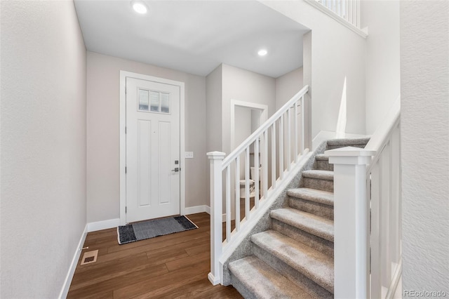 1632 Saddlesmith Pl, Castle Pines, CO 80108 - entrance foyer featuring stairs, wood finished floors, and recessed lighting
