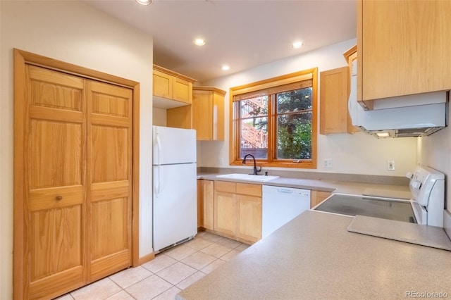 kitchen featuring recessed lighting, light countertops, light brown cabinets, a sink, and white appliances