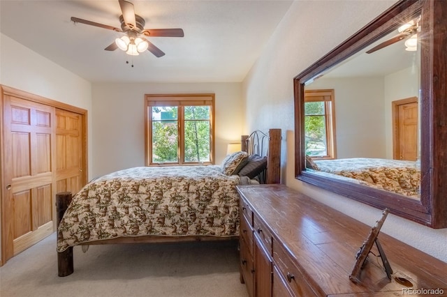 bedroom with carpet floors, multiple windows, and a ceiling fan