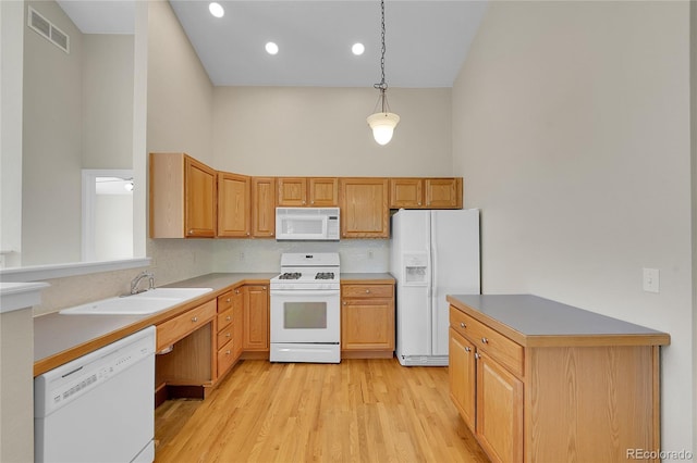 11268 Grove St Unit I, Westminster, CO 80031 - kitchen with white appliances, light wood-type flooring, decorative light fixtures, recessed lighting, and light countertops