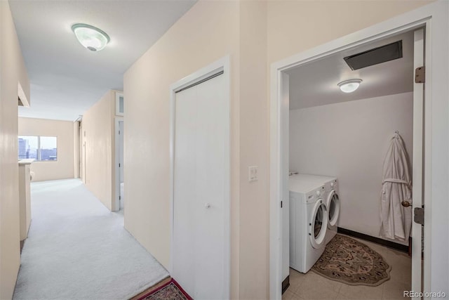 clothes washing area with independent washer and dryer and light colored carpet