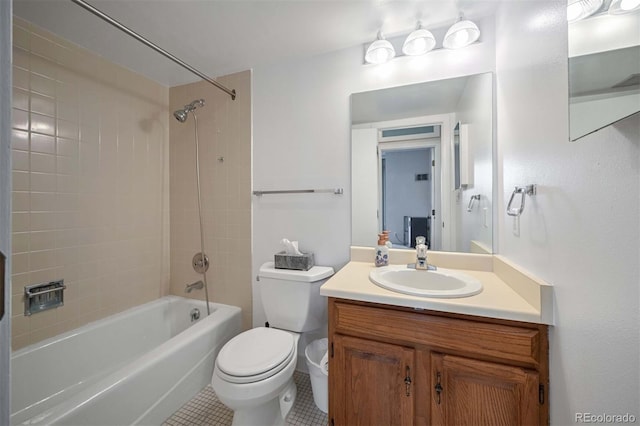 full bathroom with tile patterned floors, toilet, vanity, and tiled shower / bath