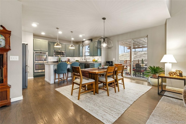 dining area featuring sink and dark hardwood / wood-style flooring