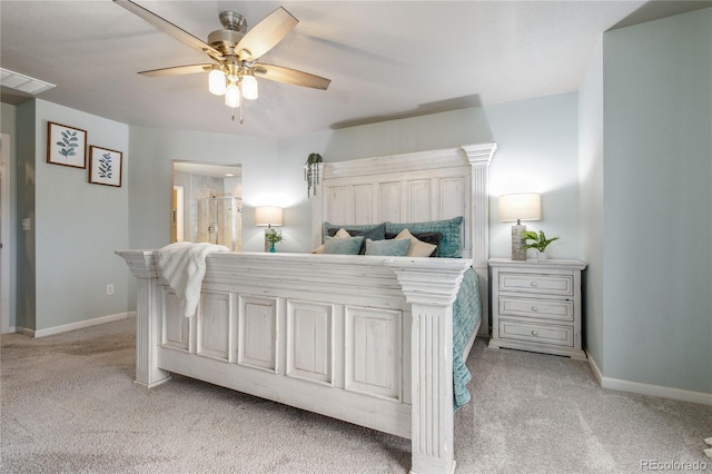 carpeted bedroom with ceiling fan and ensuite bath