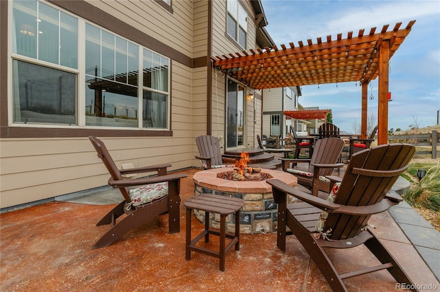 view of patio featuring an outdoor fire pit and a pergola