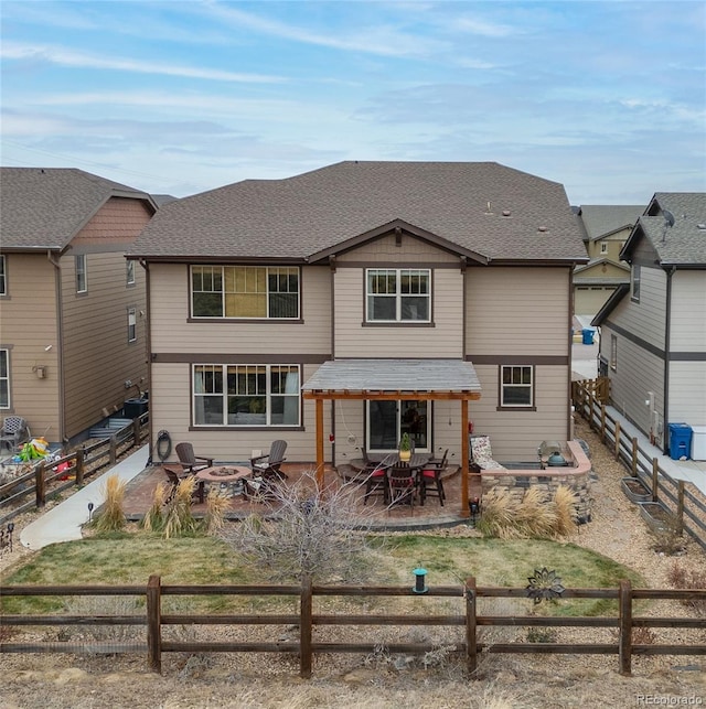 back of house featuring a fire pit and a patio