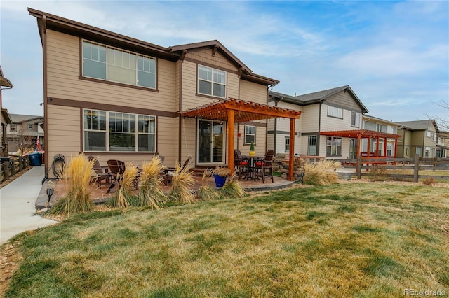 rear view of house with a patio, a yard, and a pergola