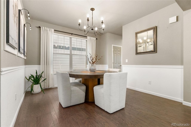 dining space featuring baseboards, a chandelier, and dark wood-type flooring