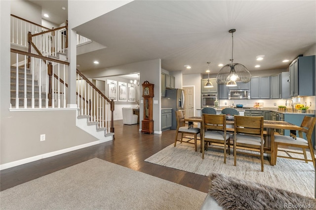 dining room featuring recessed lighting, dark wood-style flooring, stairway, and baseboards