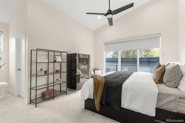 carpeted bedroom featuring ceiling fan, high vaulted ceiling, and access to exterior