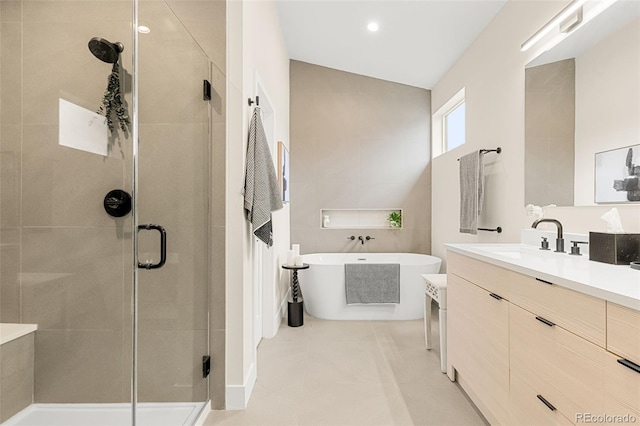 bathroom featuring plus walk in shower, tile patterned flooring, and vanity