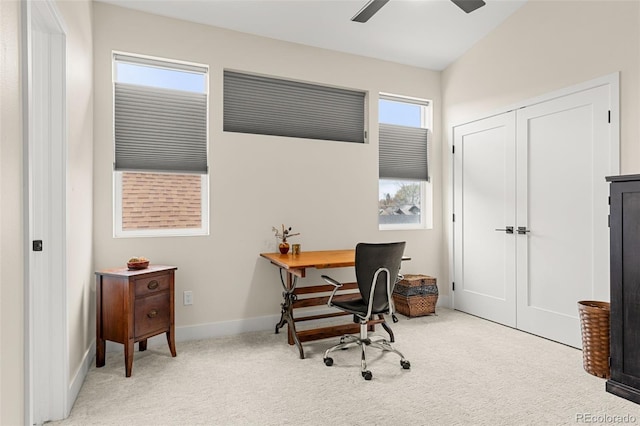 carpeted office space with ceiling fan