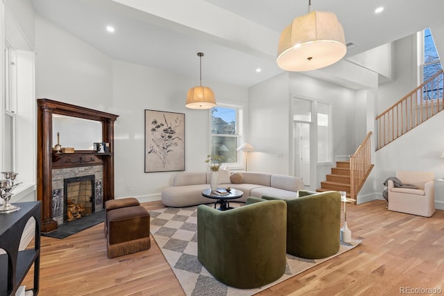 living room with a high ceiling and light hardwood / wood-style flooring