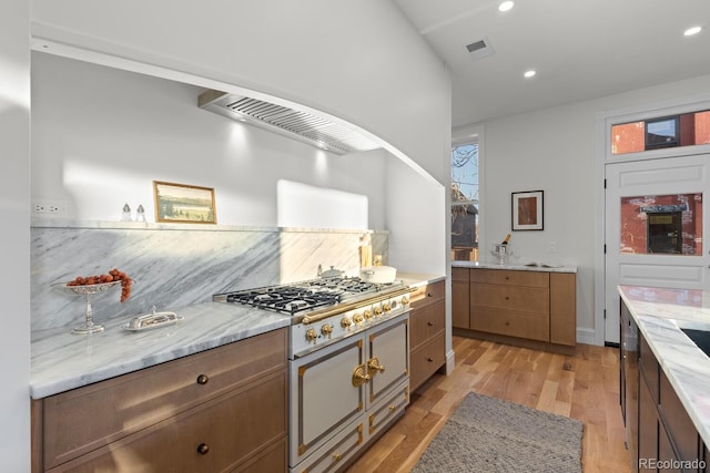 kitchen with light wood finished floors, visible vents, light stone counters, stainless steel gas stovetop, and recessed lighting