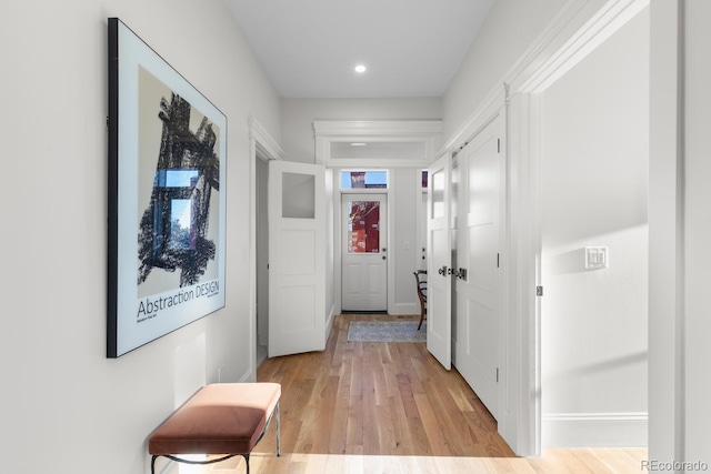 hallway with light hardwood / wood-style flooring