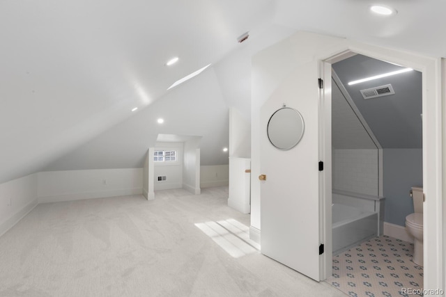 additional living space featuring lofted ceiling and light colored carpet