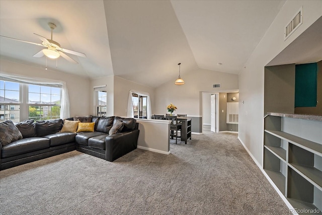 living room featuring ceiling fan, carpet flooring, plenty of natural light, vaulted ceiling, and baseboards