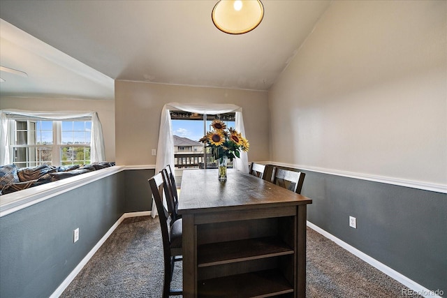 carpeted dining space featuring baseboards