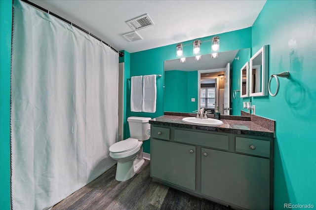 full bathroom with wood finished floors, toilet, vanity, and a shower with curtain