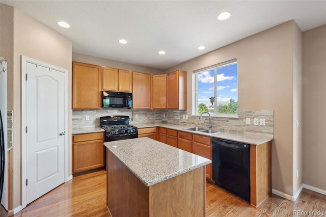 6612 Big Leaf Ln, Colorado Springs, CO 80927 - kitchen featuring black appliances, tasteful backsplash, light wood-style flooring, and recessed lighting
