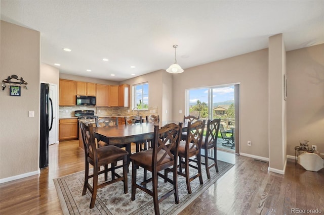 6612 Big Leaf Ln, Colorado Springs, CO 80927 - dining space with light wood-style floors and recessed lighting