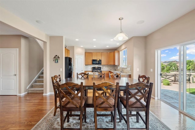 6612 Big Leaf Ln, Colorado Springs, CO 80927 - dining room with light wood-style flooring, stairs, and recessed lighting