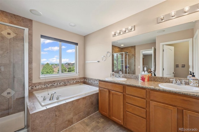 6612 Big Leaf Ln, Colorado Springs, CO 80927 - bathroom with double vanity, a garden tub, and a stall shower