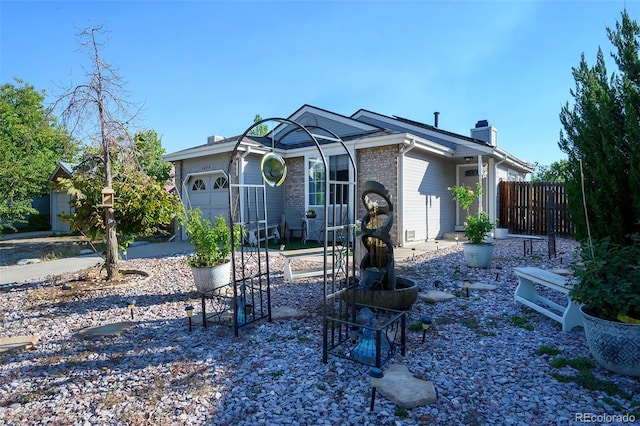 rear view of house with a garage