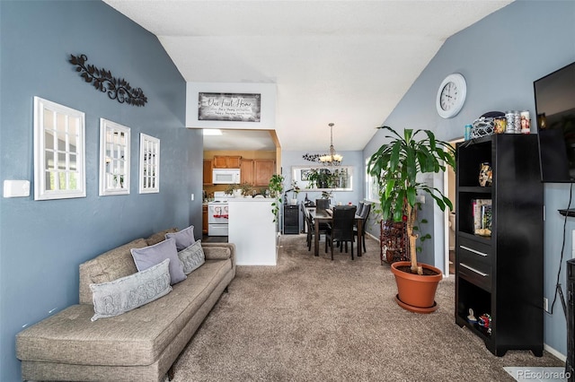 living room with carpet, vaulted ceiling, and a chandelier