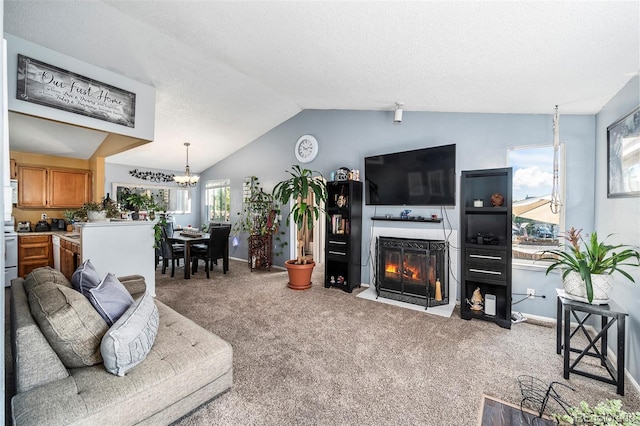 carpeted living room with lofted ceiling, a chandelier, and a textured ceiling