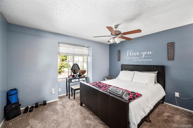 bedroom featuring ceiling fan, carpet floors, and a textured ceiling