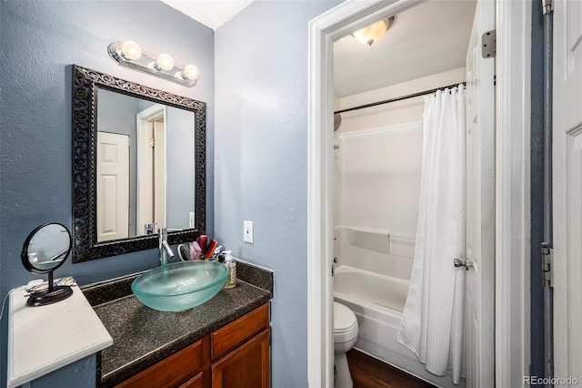 full bathroom featuring shower / bath combo, vanity, and toilet