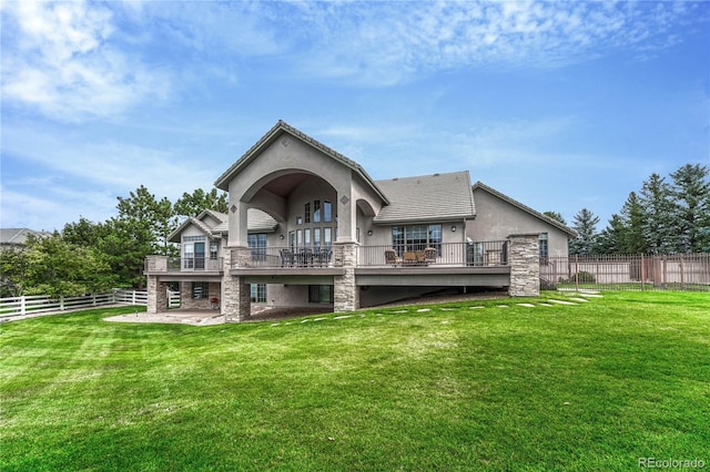 back of property with a patio area and a yard