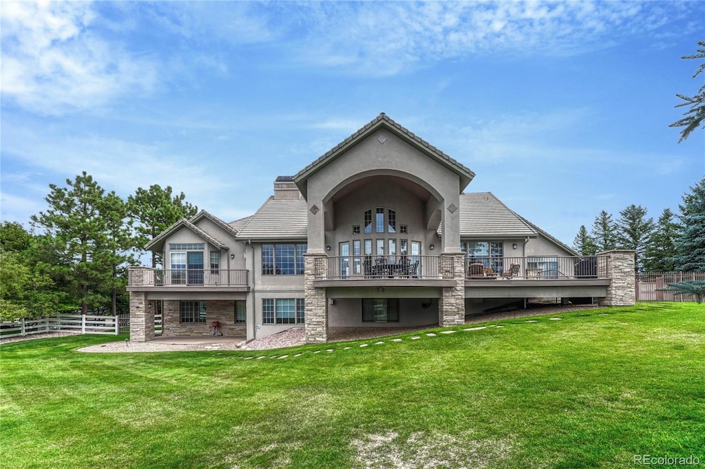 rear view of house featuring a yard and a patio area