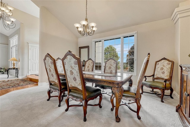 dining room with high vaulted ceiling, light hardwood / wood-style flooring, and a notable chandelier