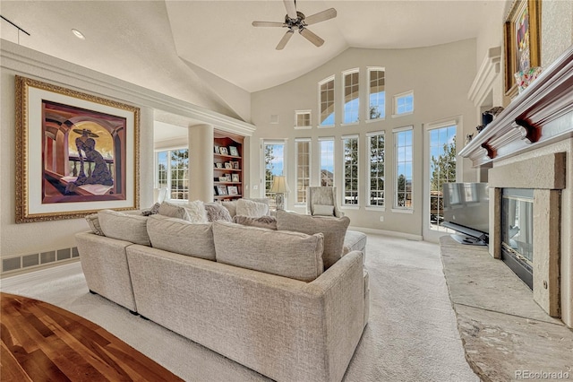 carpeted living room featuring vaulted ceiling, ceiling fan, and plenty of natural light