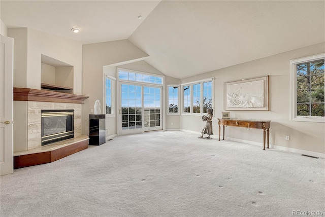 unfurnished living room with carpet and vaulted ceiling