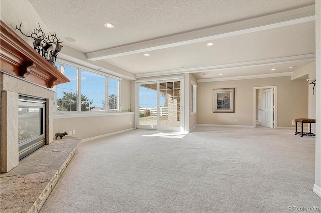 unfurnished living room with a textured ceiling, a premium fireplace, beamed ceiling, and light carpet