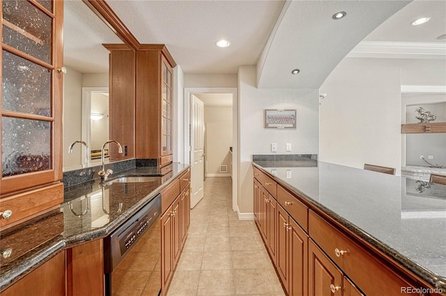 kitchen with dark stone counters, a textured ceiling, light tile patterned floors, sink, and dishwasher