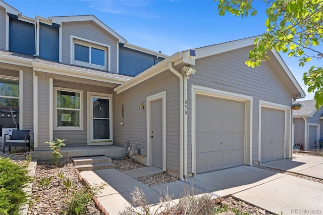 11050 Gaylord St, Northglenn, CO 80233 - view of front facade featuring driveway, an attached garage, and covered porch