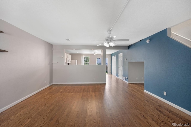 11050 Gaylord St, Northglenn, CO 80233 - unfurnished living room with wood finished floors, a ceiling fan, and baseboards