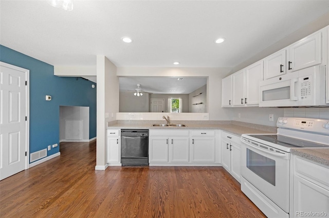 11050 Gaylord St, Northglenn, CO 80233 - kitchen with white appliances, a sink, dark wood-style floors, light countertops, and white cabinets