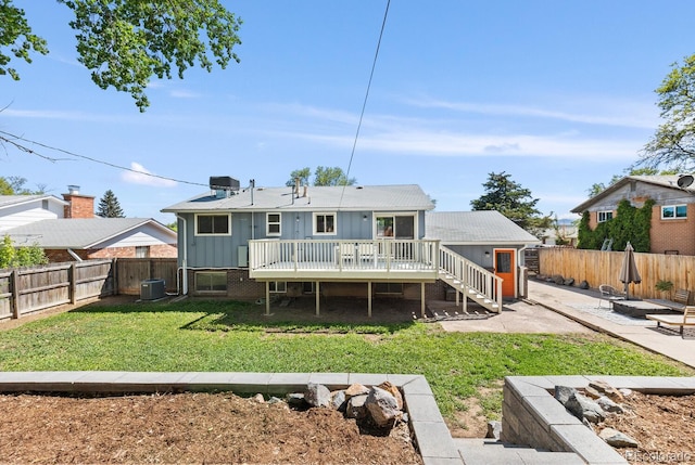 4381 Dixon Dr, Westminster, CO 80031 - back of property featuring central AC, a deck, a patio area, board and batten siding, and a fire pit